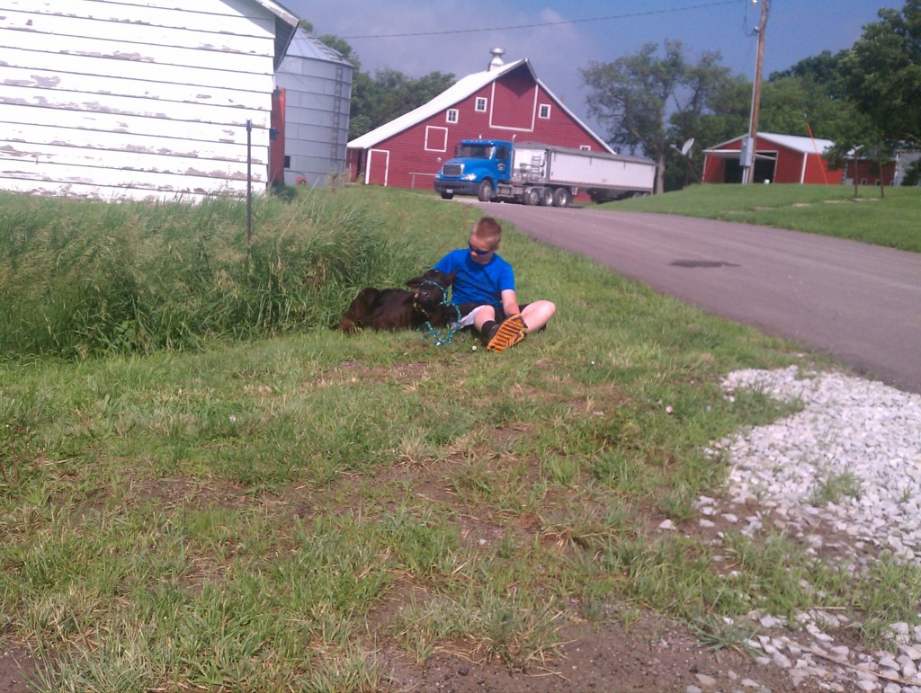 As I rode up I thought this was a boy with his dog.  No!  It was a one month old calf.  Cutest thing, real curious, actually reminded me of a puppy.